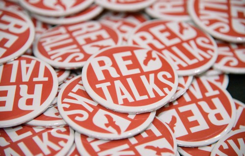 A pile of buttons that say Red Talks