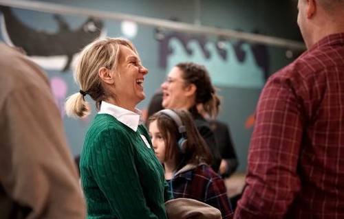 Woman laughing in conversation 
