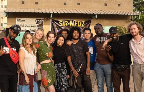 Photo featuring SU study abroad students with rappers in Senegal