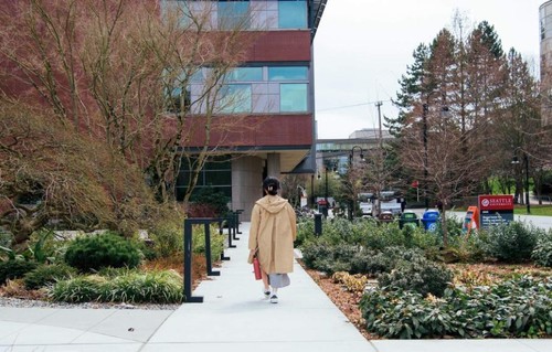 Back of a girl walking towards the School of Law at Seattle University
