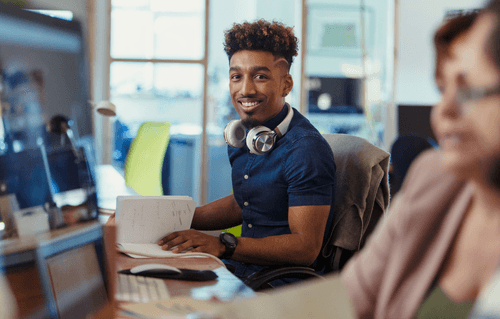 Man with headphones around his neck with a book