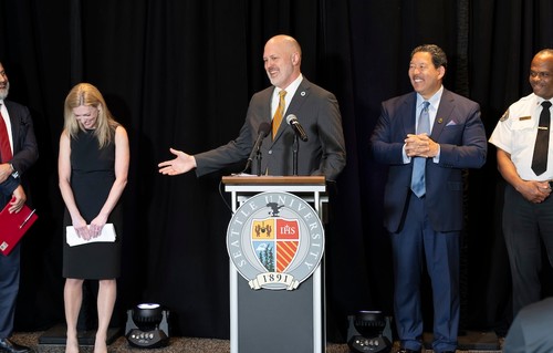 SU President Eduardo Peñalver and Seattle Mayor Bruce Harrell join CARE chief Amy Smith, Seattle City Council member Robert Kettle (at the podium) and Seattle Fire Chief Harold Scoggins.