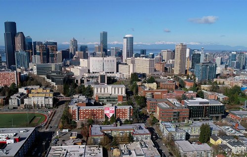 An aerial shot of the campus with the Seattle skyline in back.