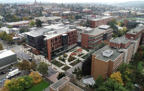 A group of buildings with trees and grass.