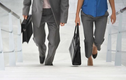 Professional MBA students walking up the stairs on campus.