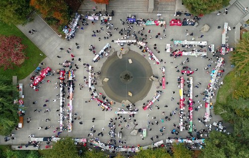 An aerial photo of students at the SU fountain