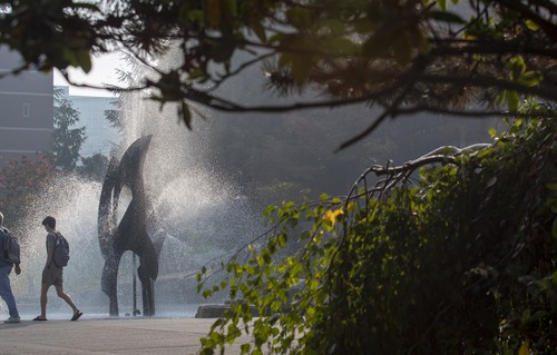 Students walking past the fountain.