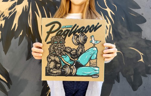 A person holding up a Pagliacci pizza box which shows Big Foot