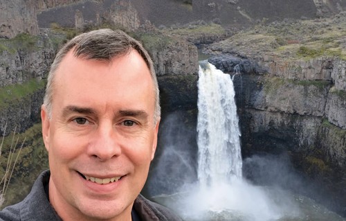 Portrait of Chris Longston with a waterfall in the background