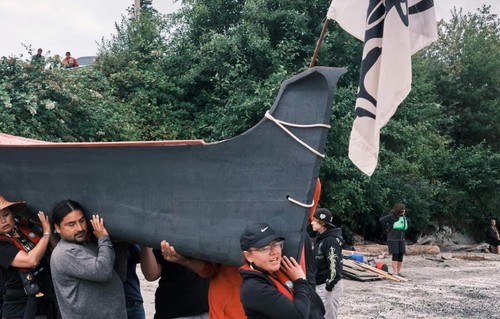 Branddi carries canoe at Alki Beach.