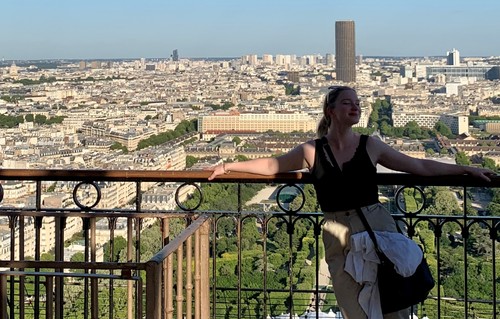 A person standing in front of a view of Paris