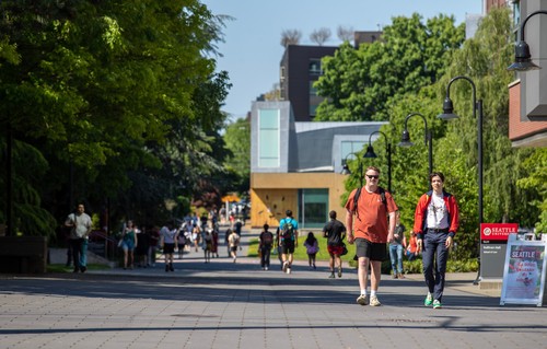 Students walking on campus with chapel in the background.