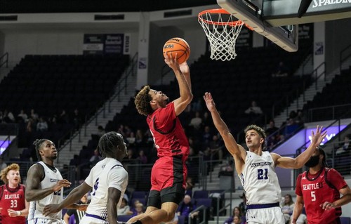 Men's basketball player goes for the hoop