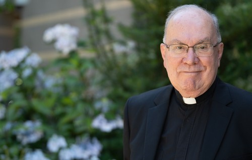 A portrait of Father Steve on campus
