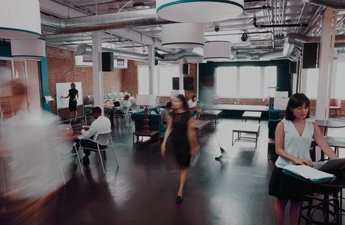 A busy office with workers walking by