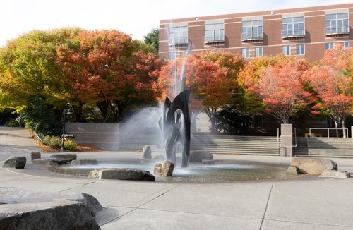 Photo of fountain with trees in background