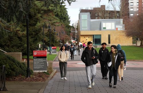 Students walking with the Chapel in the background