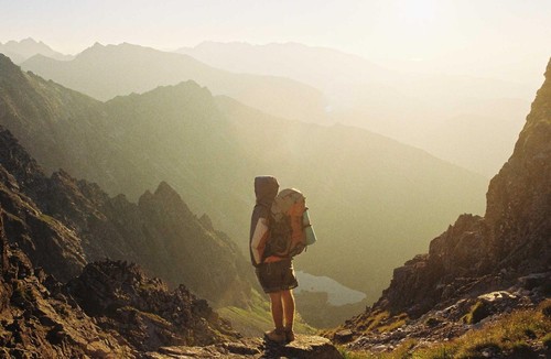 Hiker standing in front of mountains