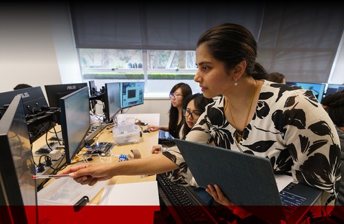 Teacher with students at a computer