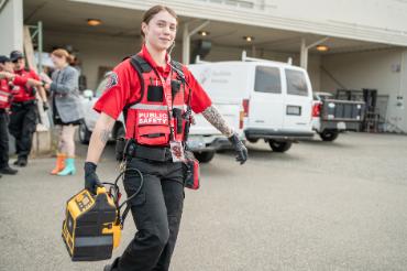 DPS officer carrying a jump starter battery pack outside